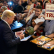 Donald Trump signing a camo hat that’s now on eBay on October 23, 2015 in Doral, Florida (Getty Images)